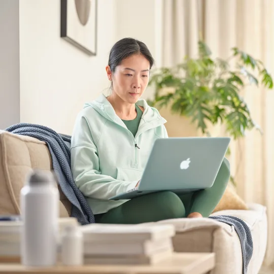 Person reviewing their wellness plan on a laptop at home